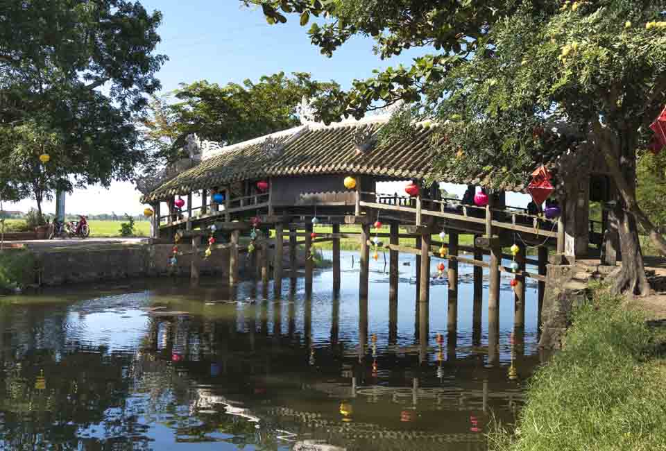 Thanh Toan tile bridge is a wooden bridge with a tile roof crossing a ditch in Thanh Thuy Chanh Village Thanh Toan tile bridge is a wooden bridge with a tile roof crossing a ditch in Thanh Thuy Chanh Village