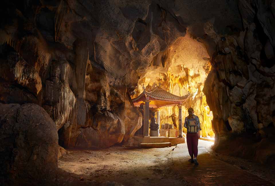 Tourist looking at cave with Thong pagoda in Tam Coc Bich Dong. Ninh Binh, Vietnam. Tourist looking at cave with Thong pagoda in Tam Coc Bich Dong. Ninh Binh, Vietnam.